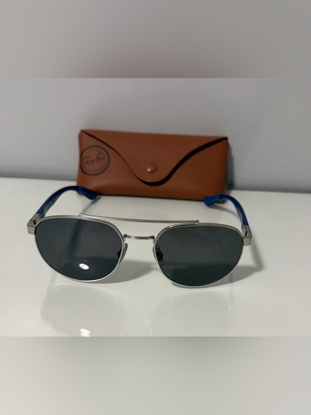 Ray-Ban Silver Frame Sunglasses with Blue Temples and Dark Lenses